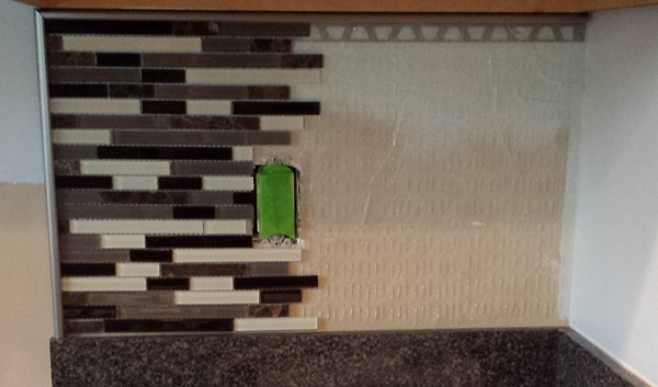 How do you design tile backsplashes around outlets?